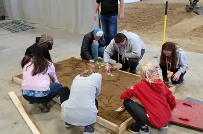 students drawing in a sandbox